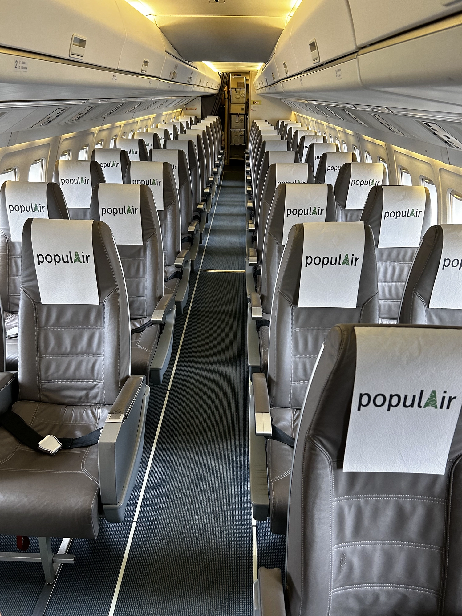 Fokker 50 interior - clean grey seats and light spacious feel